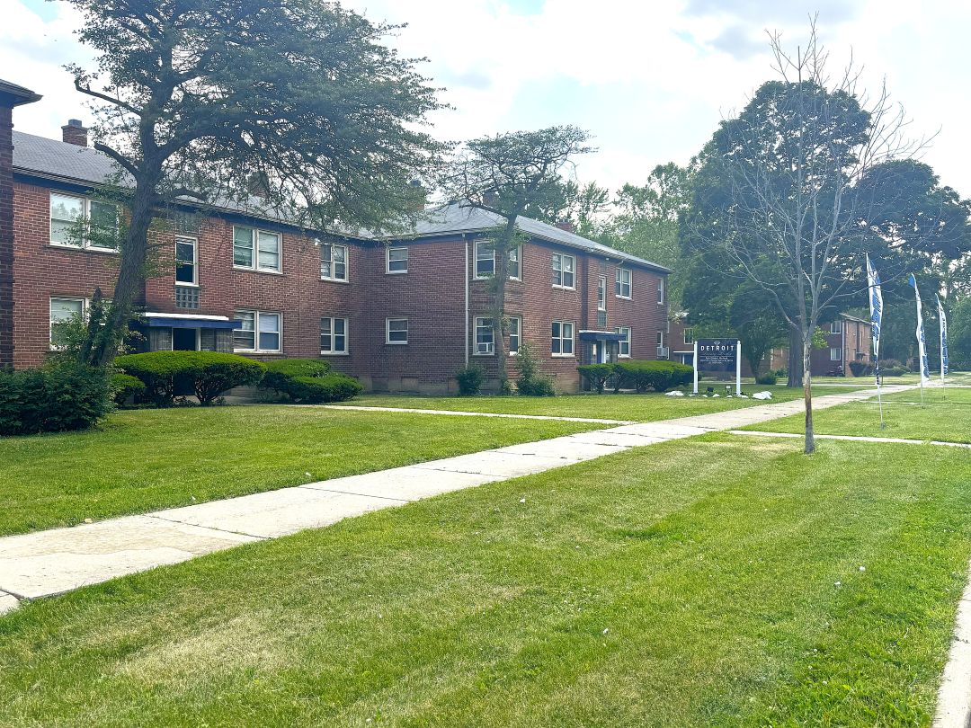 Red brick Detroit Luxury Living apartment buildings and landscaped lawns